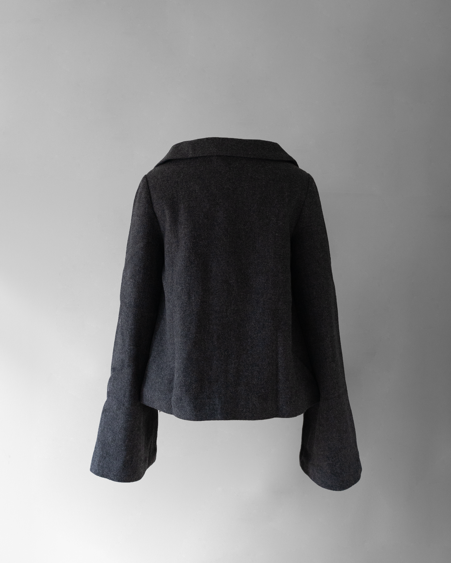 back photo of hello! jacket, a dark grey wool jacket with a wide collar, invisible buttons except for the top button, and long sleeves.