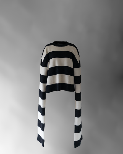 front photo of notebook sweater, a black and white striped sweater with very long sleeves floating on a light grey background.